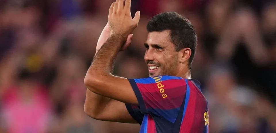 Player celebrating and applauding fans at stadium