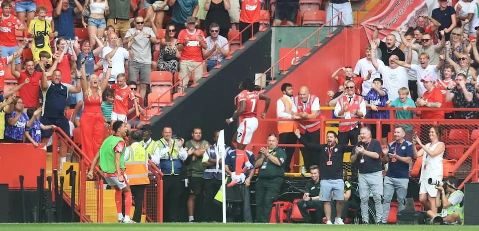 Fans celebrating as player scores a goal
