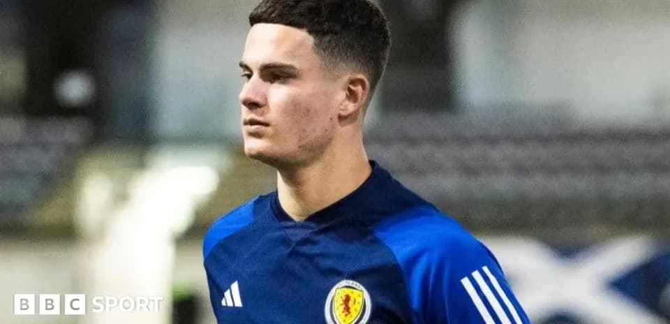 Player in Scotland training kit on the pitch