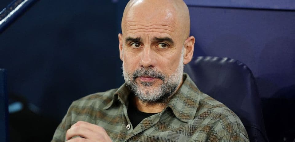 Coach seated on bench during match