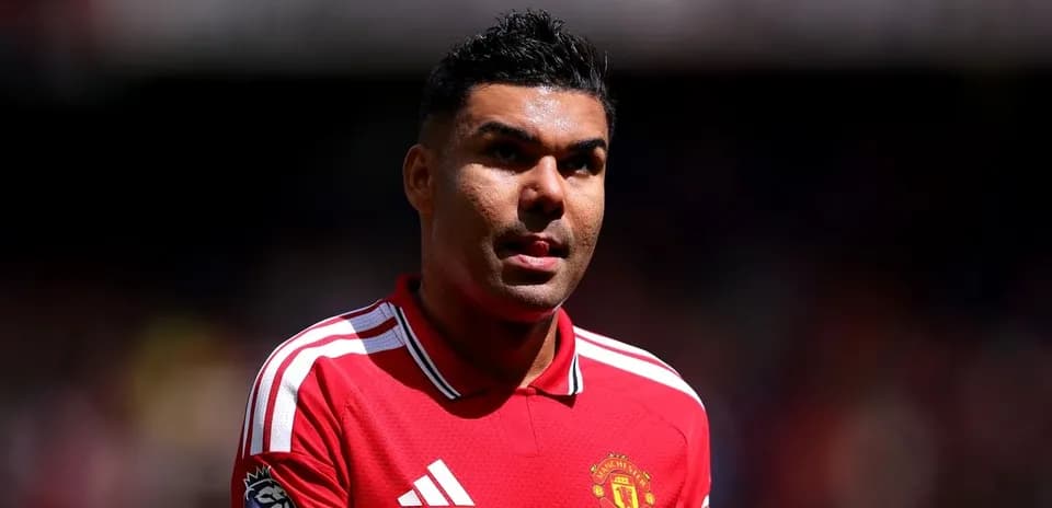 Football player in Manchester United jersey on field
