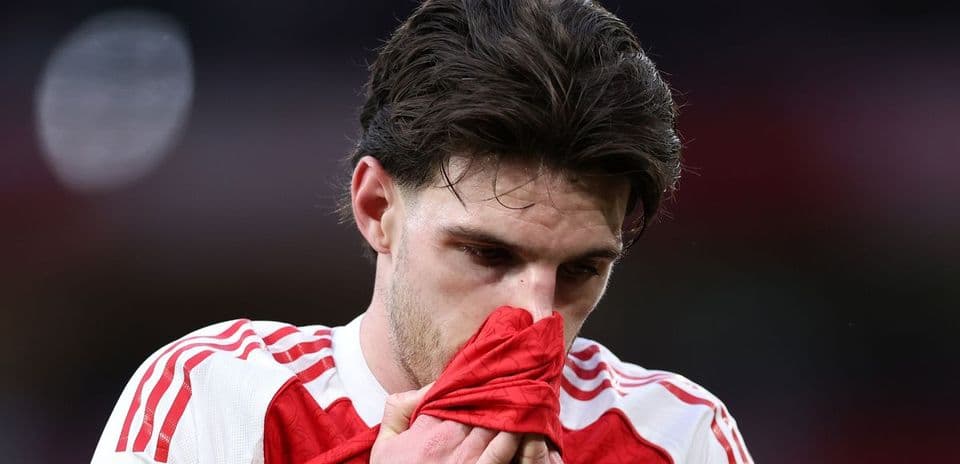 Player holding jersey, looking down in disappointment