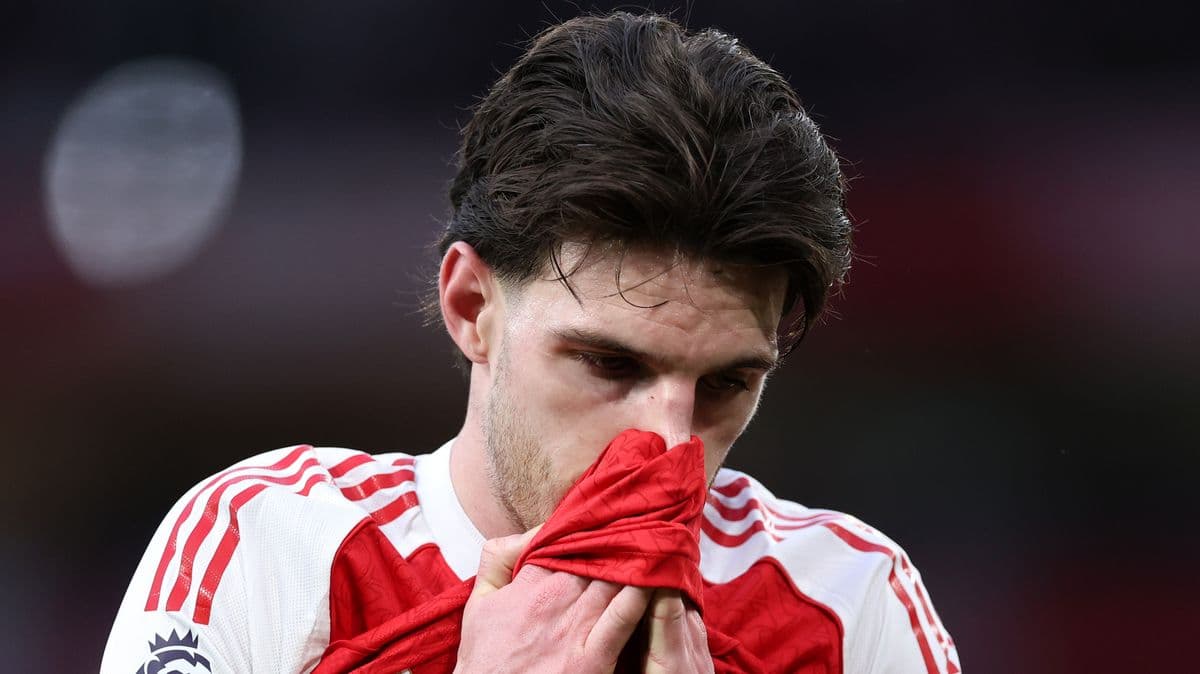 Player holding jersey, looking down in disappointment