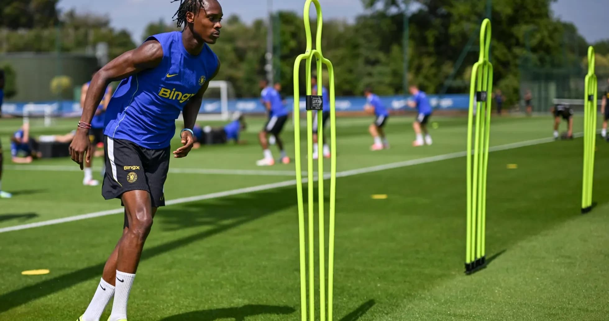 Player training with agility poles on practice field