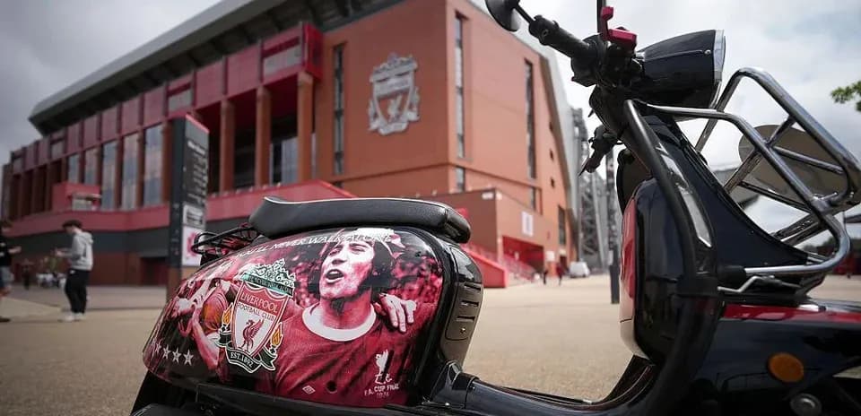 Scooter decorated with Liverpool FC artwork outside stadium