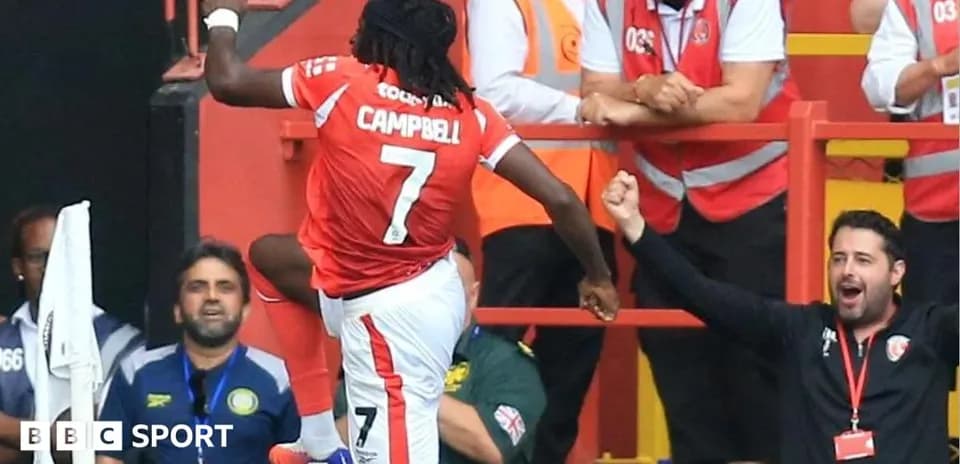 Player celebrating a goal with fans in background