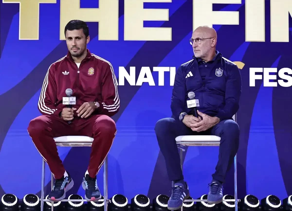 Two coaches seated at press conference podium