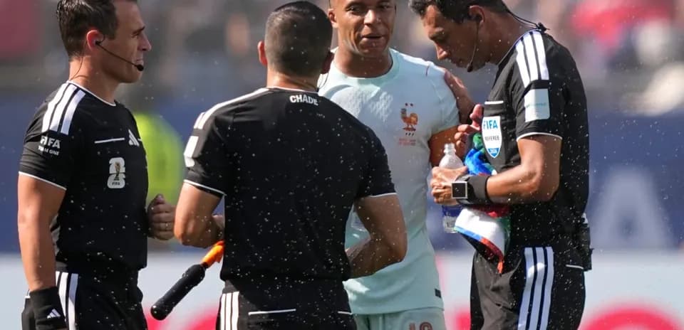 Referees discussing with player during match stoppage