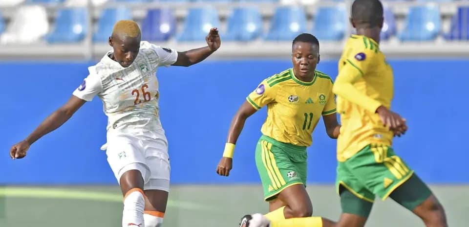 Ivorian player kicking the ball in match action