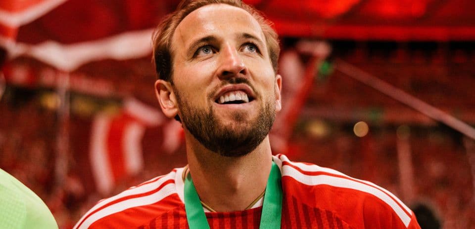 Player celebrating with medal in stadium atmosphere