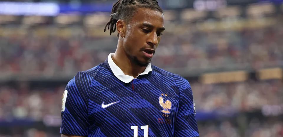 Player in France kit during match, looking down