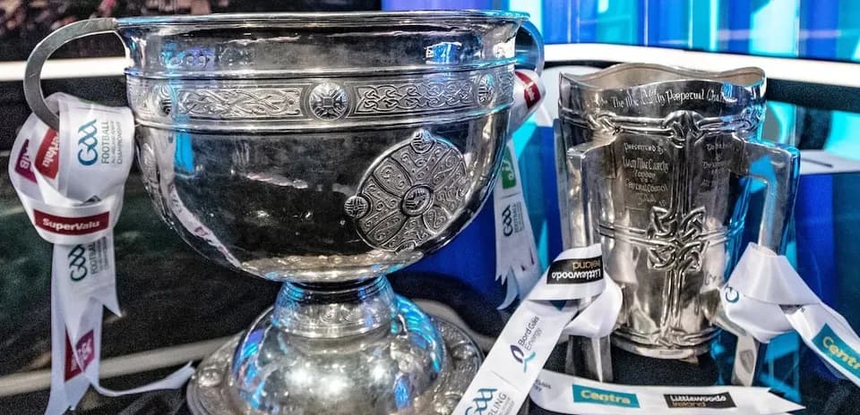 Two silver trophies with ribbons on display