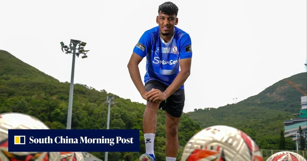 Player posing with footballs on training ground