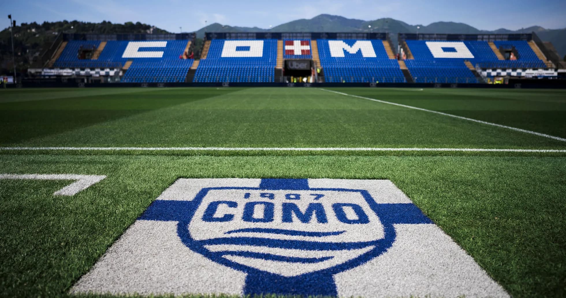 Stadium field with Como logo and seating area