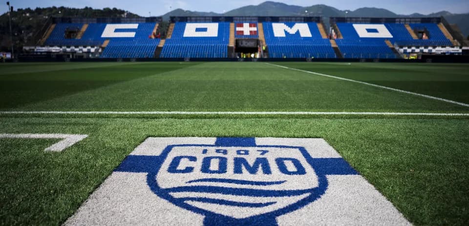 Stadium field with Como logo and seating area
