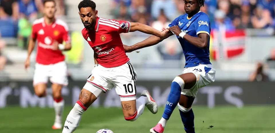Player dribbling past opponent during football match
