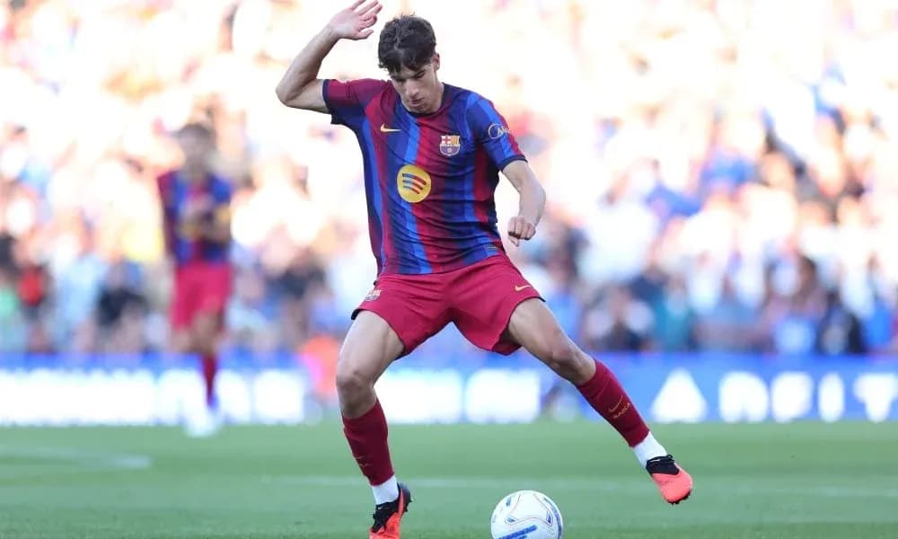 Player in Barcelona kit dribbling the ball on pitch