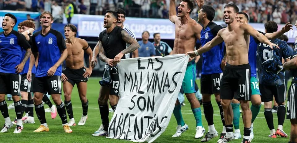 Argentina players celebrating with a banner after match