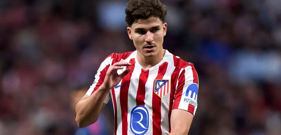 Player in Atlético Madrid jersey gesturing on field