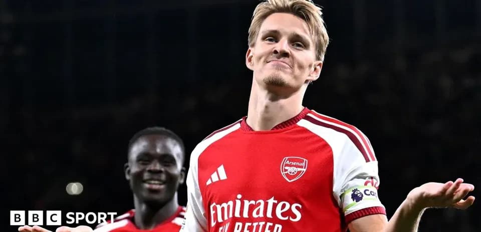 Arsenal player celebrating with teammate after scoring