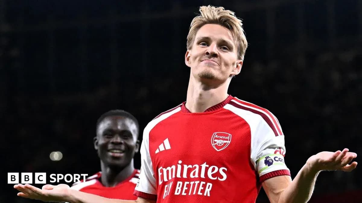 Arsenal player celebrating with teammate after scoring