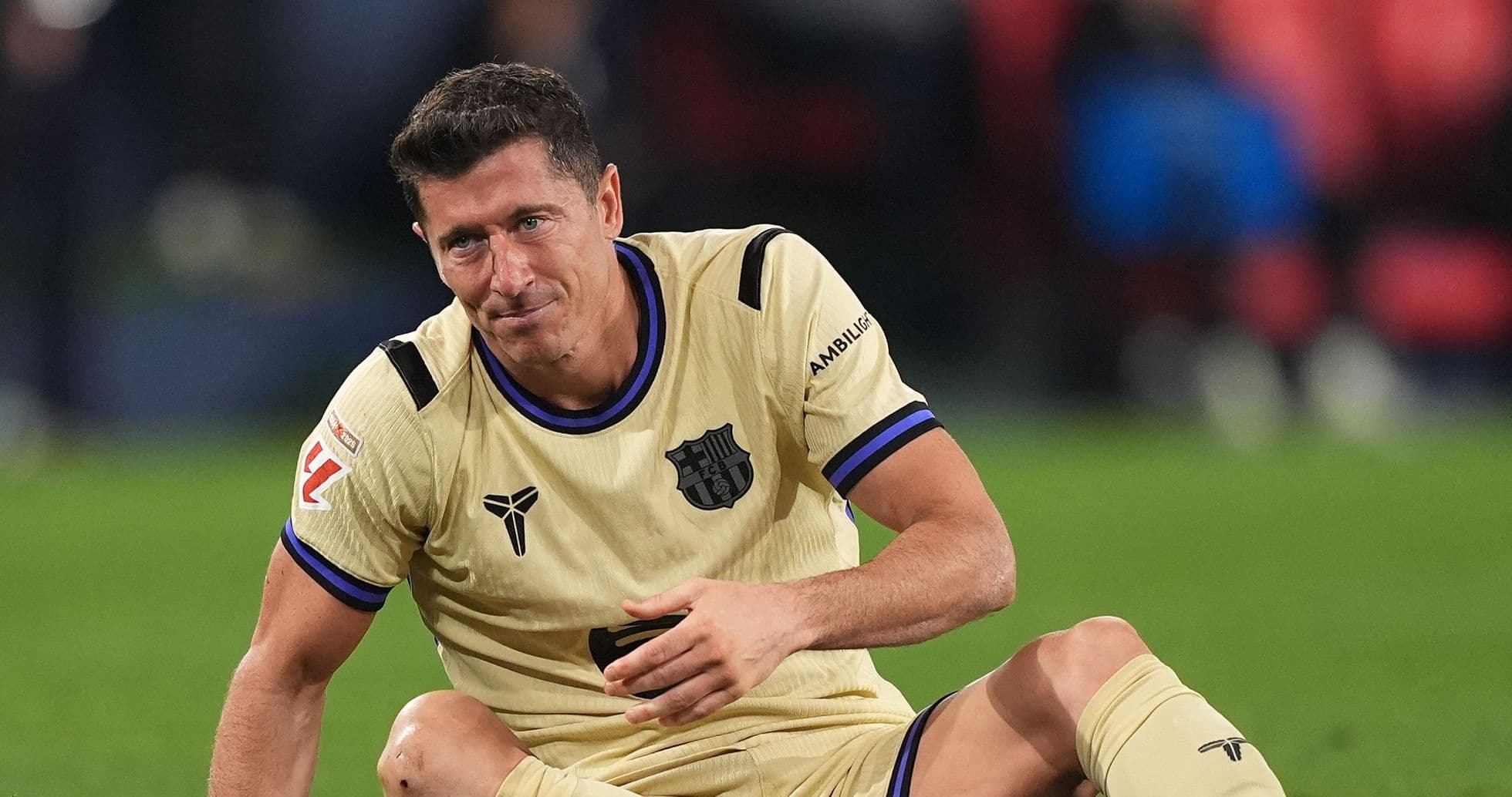 Player sitting on the pitch in Barcelona jersey