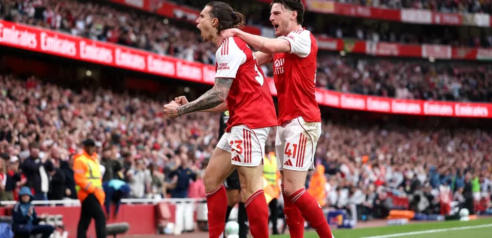 Arsenal players celebrating a goal on the pitch