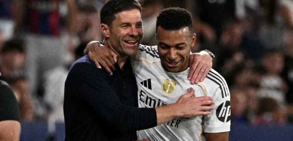 Coach and player celebrating on the field together