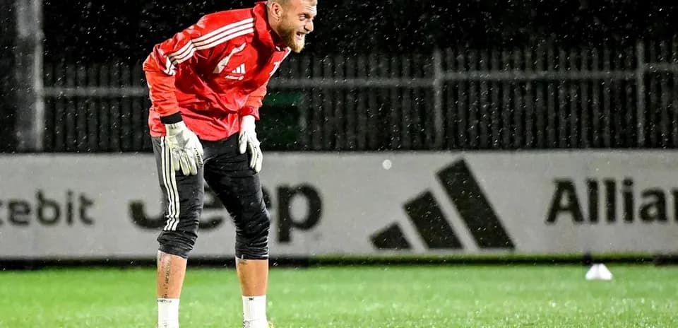 Goalkeeper practicing in the rain during training