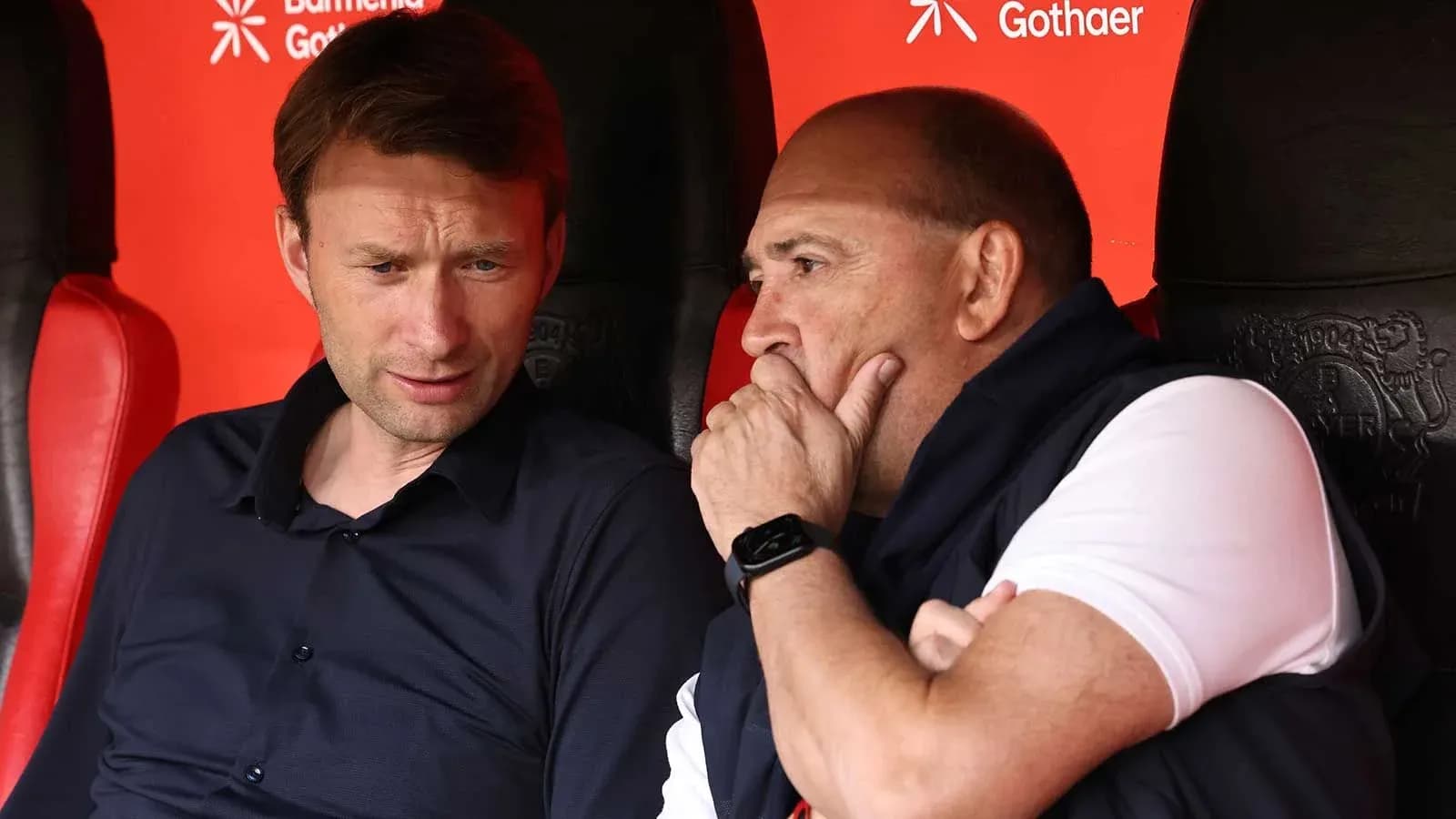 Coaches discussing strategies on the bench
