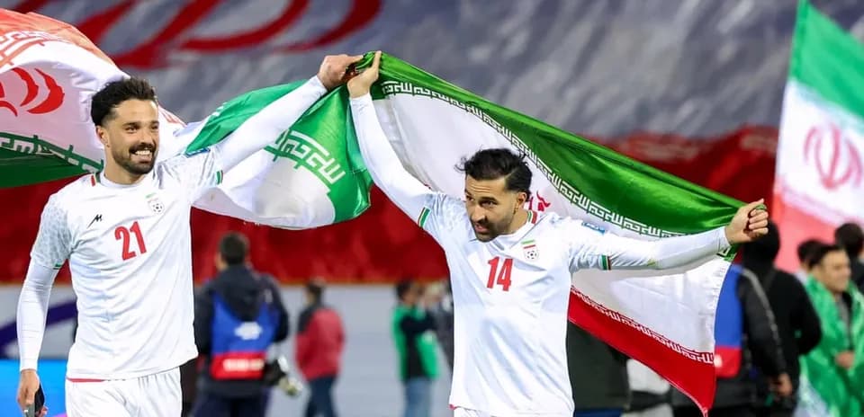 Iran players celebrating with national flags