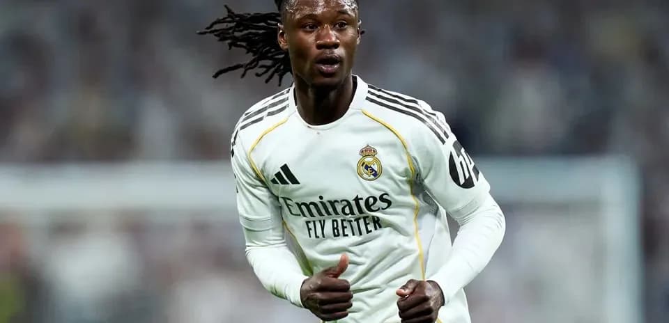 Player running on field wearing Real Madrid jersey