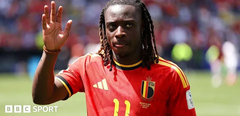 Player waving while wearing Belgium national team jersey
