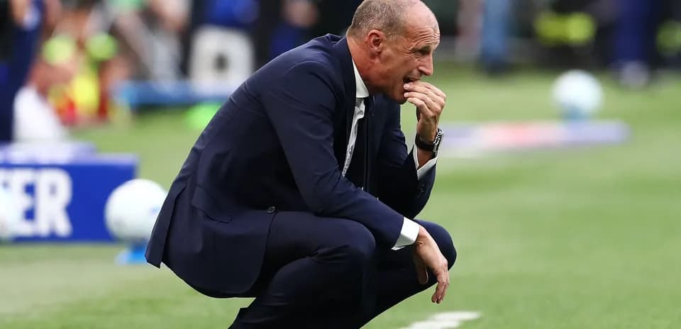 Coach kneeling on the sidelines during match