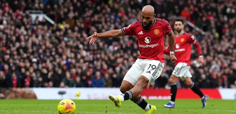 Manchester United player taking a shot at goal