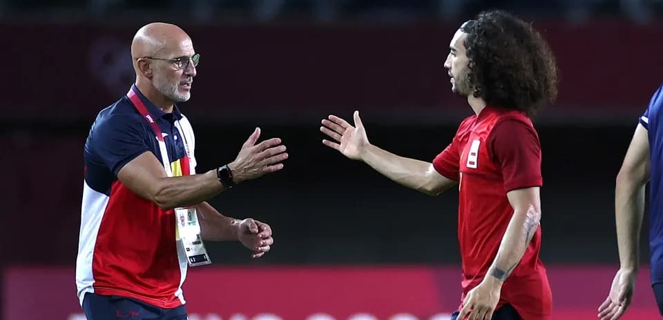 Coach and player shaking hands on the field