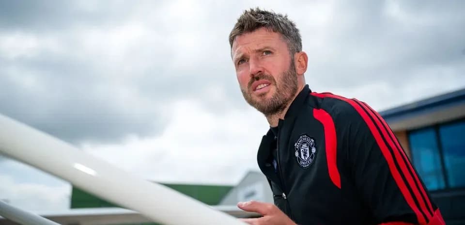 Coach observing from stairs at training facility