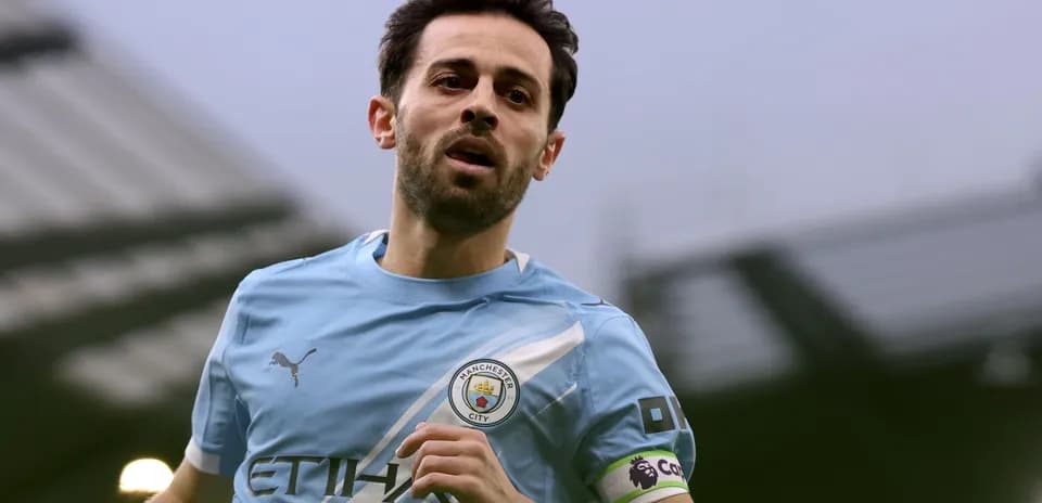 Player wearing Manchester City kit running on field