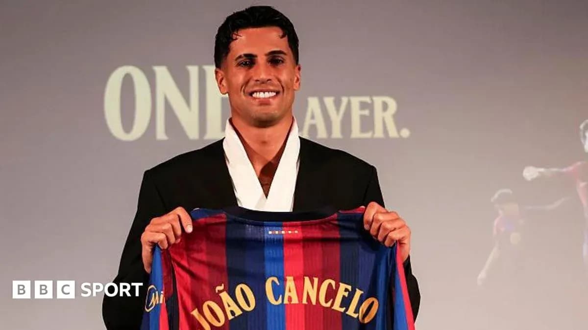 Player holding Barcelona jersey at presentation event