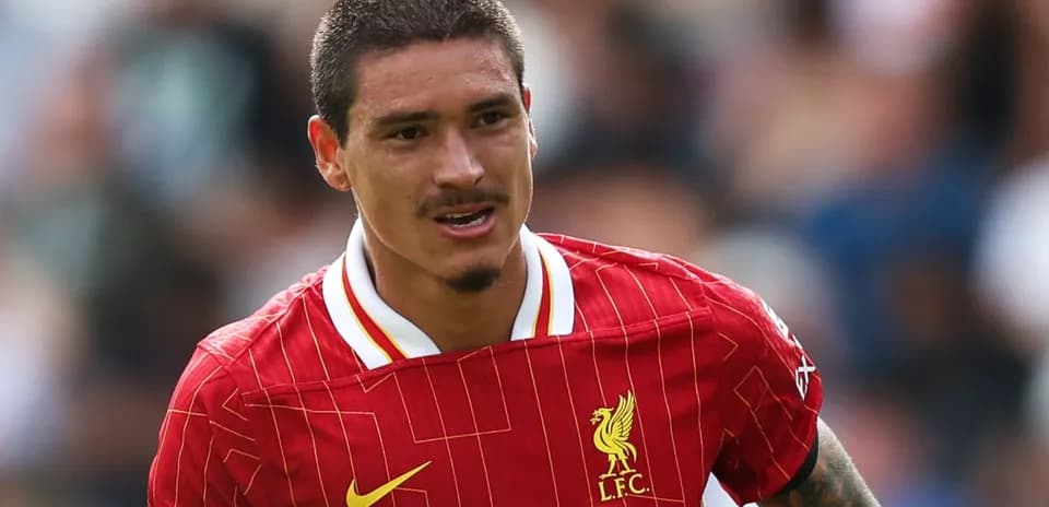 Player running in Liverpool jersey during match
