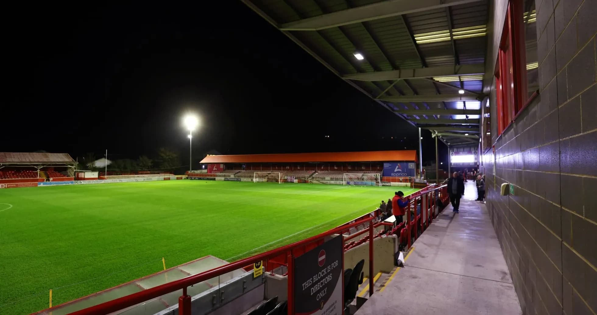 View of stadium with illuminated pitch at night