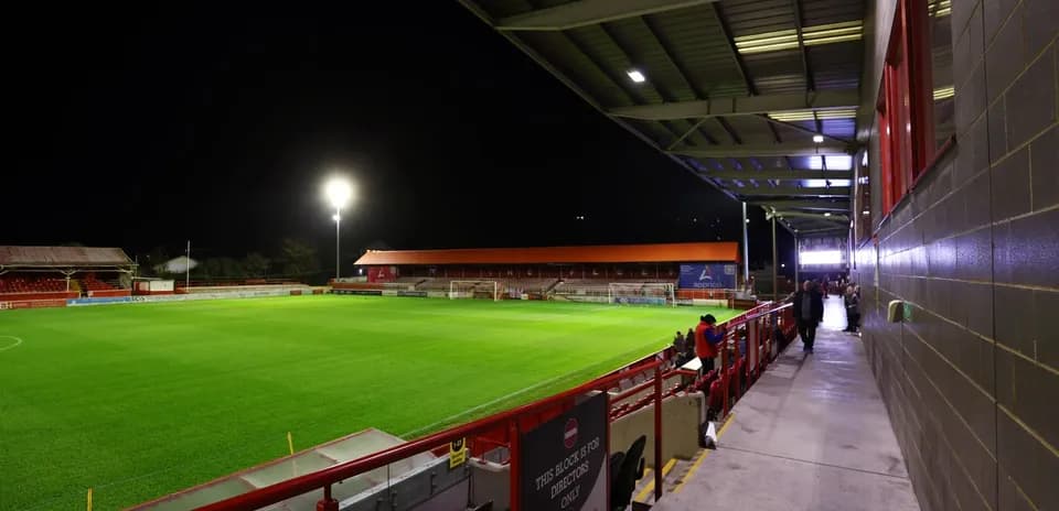 View of stadium with illuminated pitch at night