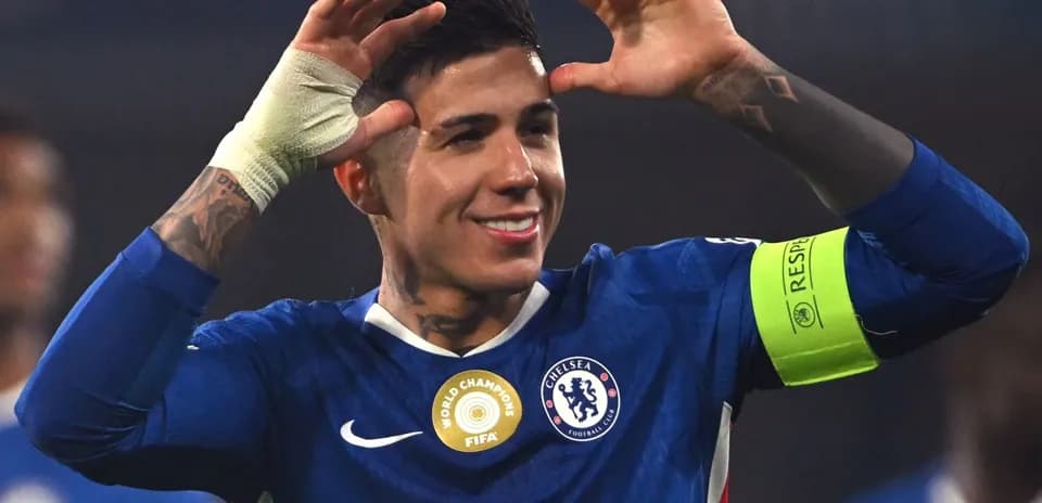 Chelsea player celebrating with arms raised