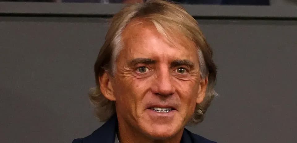 Coach smiling in a stadium setting
