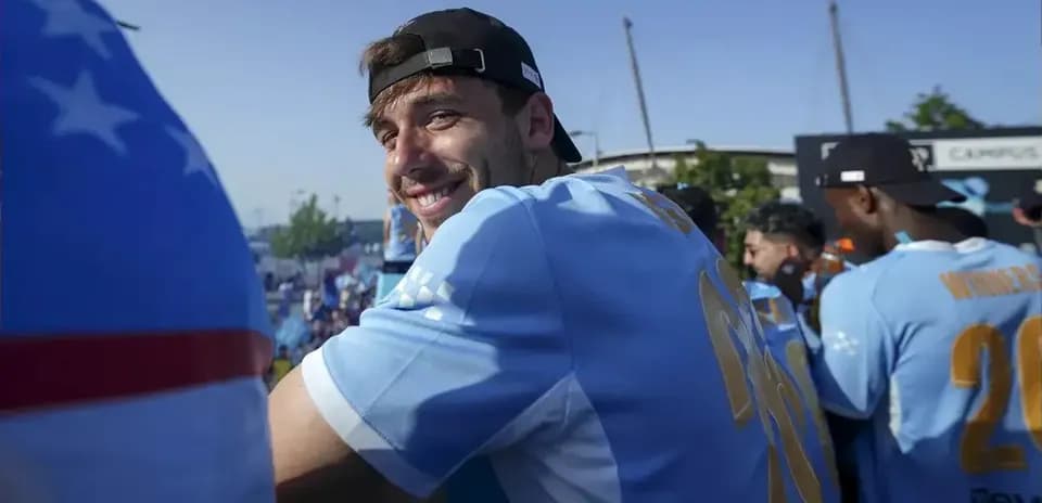 Player smiling in team jersey at event