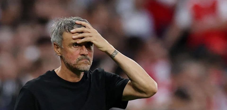 Manager with hand on forehead during match