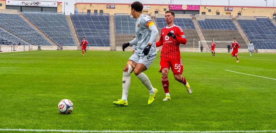 Goalkeeper preparing to pass ball during match