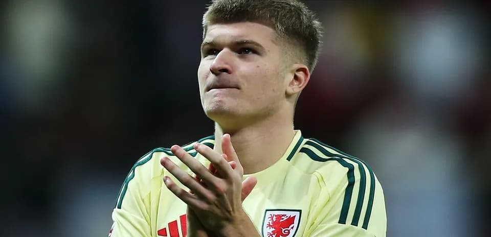 Player applauding fans wearing yellow kit