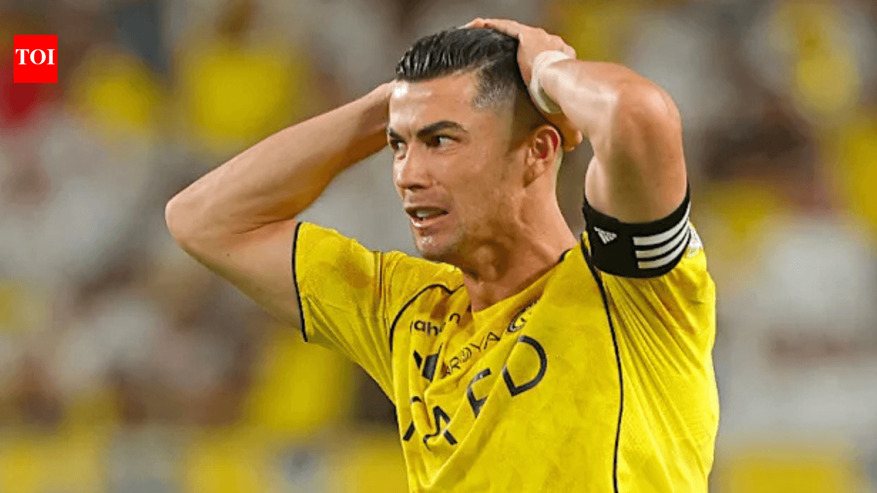 Player in yellow jersey holding head during match