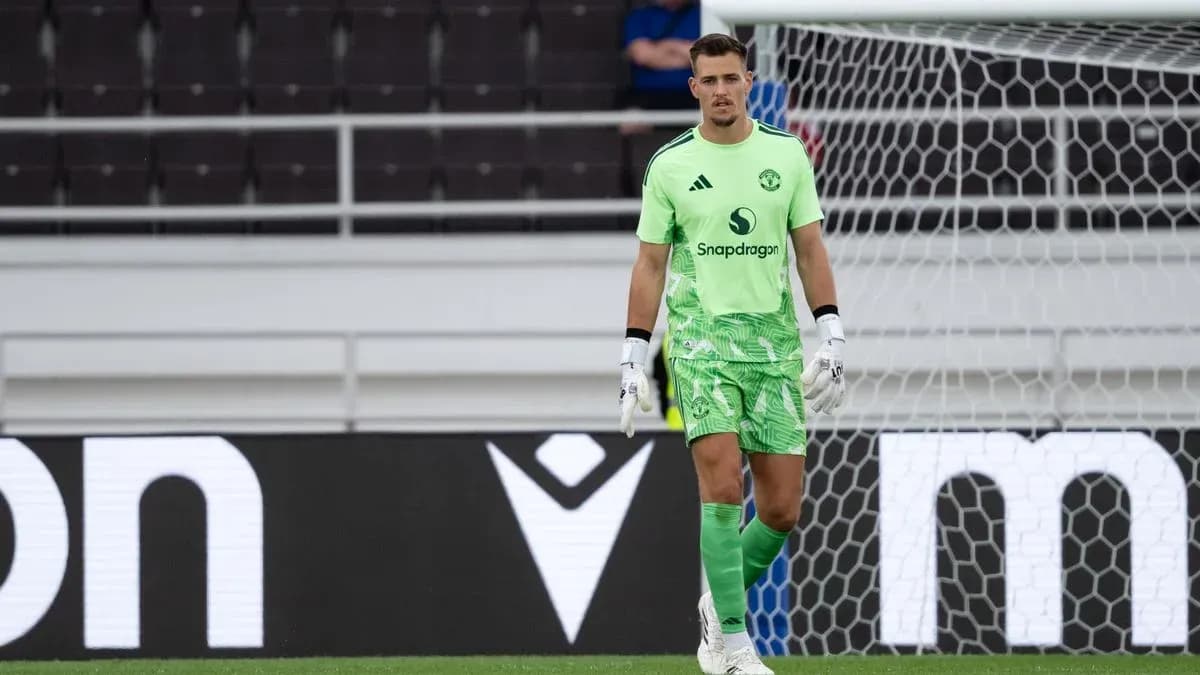 Goalkeeper in green kit standing in goal area